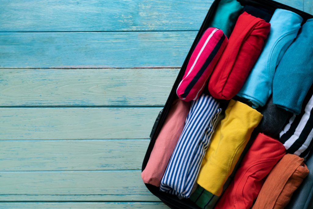 Rolled colorful clothes in a luggage