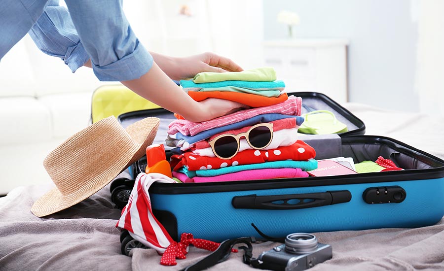 A female traveler packing her luggage