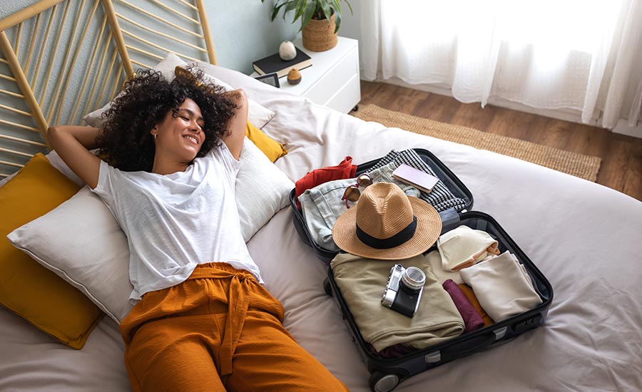 A woman lying beside her suitcase